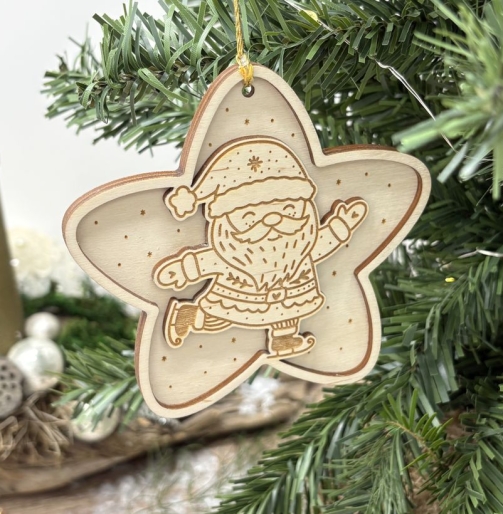 Nahaufnahme eines sternförmigen Holz Weihnachtsanhängers mit fröhlichem, Schlittschuh laufendem Weihnachtsmann, detailreicher Gravur, kleinen Sternen und goldener Aufhängeschnur am Christbaum.